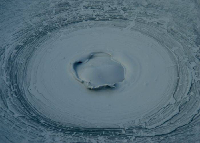 A close-up of the bubbling gray mud of Oniishibozu Hell.